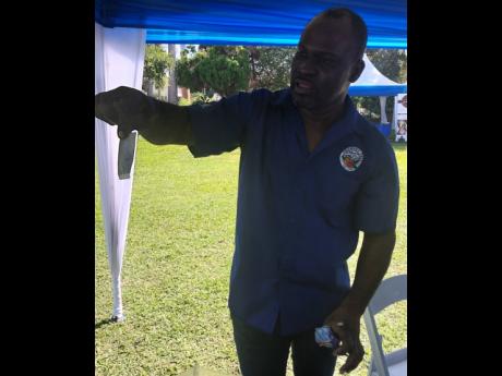 CEO and founder of Trumpet Tree Coffee Factory Arthur McGowan shows off a sachet of his coffee tea bag during Tuesday’s launch of the 2023 Jamaica Blue Mountain Coffee Festival at the Edward Seaga Suite, Devon House. The festival which will take place at