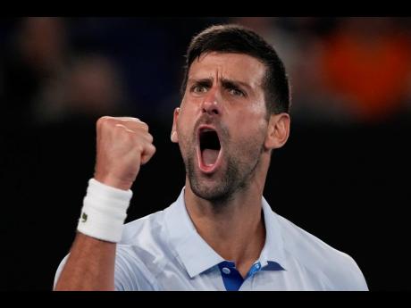 Serbia’s Novak Djokovic celebrates after winning the third set against Croatia’s Dino Prizmic during their first round match at the Australian Open Tennis Championships at Melbourne Park, Melbourne, Australia yesterday.