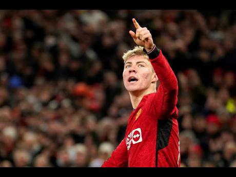 Manchester United’s Rasmus Hojlund celebrates after scoring his side’s opening goal during the English Premier League match between Manchester United and Tottenham Hotspur at the Old Trafford stadium in Manchester, England yesterday.