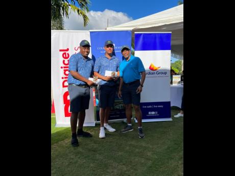 From left, winners Oshane Haye and Zandre Roye are joined by Wayne Williams, chief executive officer, Couples Resorts, after scoring 59, 12 under par, to defend their Ocho Rio’s Charity Golf Tournament title at the 22nd staging held at the Sandals Golf a