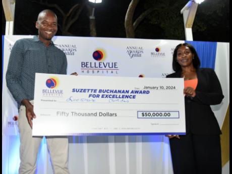 Lueshane Gordon (left) accepts the Suzette Buchanan Awards for Excellence cash prize from CEO of Bellevue Hospital, Suzette Buchanan, after he was named team player of the year during the Bellevue Hospital Awards Gala held at the hospital in Kingston on We