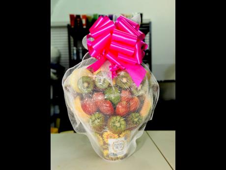 Packaged and ready to go, this edible arrangement features kiwis, pineapples and strawberries.