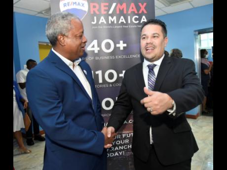 Senator Matthew Samuda (right), minister without portfolio in the Ministry of Economic Growth and Job Creation, congratulates O’Neil Kirlew (left), country manager/director of growth and expansion, Re/Max Jamaica on the launching of Re/Max Jamaica Confer