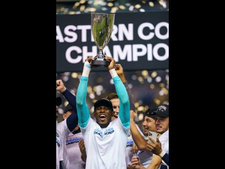 Philadelphia Union’s Andre Blake raises the trophy after his team defeated New York City FC in the MLS Eastern Conference final in 2022.