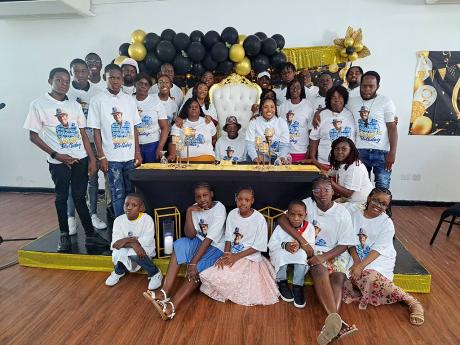 Ivan Sterling (centre, seated) in a group shot with members of his family during a celebratory dinner to mark his 100-year milestone at the Meet Conference and Event Centre in Montego Bay, on Sunday, January 14.