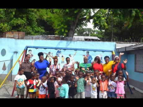 The Shipping Association of Jamaica staff with the teachers and students of the Marcus Garvey Basic School during their Christmas treat last December.