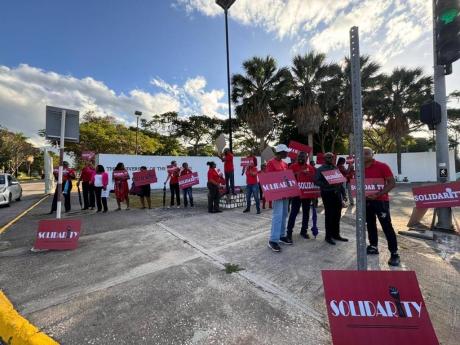 Protesters outside the gate of The University of the West Indies Mona campus on Monday. 