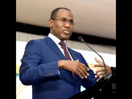 Ian Allen/Photographer 
Dr Nigel Clarke (left), minister of finance and the public service, addresses members of the audience on day two of the 19th Regional Investments and Capital Markets Conference 2024 at The Jamaica Pegasus hotel in New Kingston on We