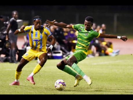 Donovan Clarke (right) of Vere United  tackles Javane Bryan of Waterhouse during their Jamaica Premier League match at the Stadium East on November 20, 2023.