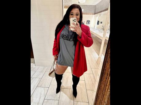 Davis takes a selfie in this chic shirt dress paired with a red coat and knee-high boots.