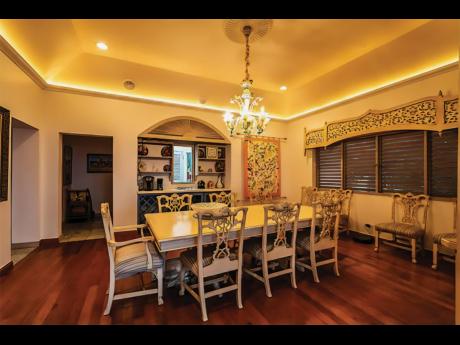 The formal dining room, with a serving bar, electrifies with its tray ceiling LED strip lighting.