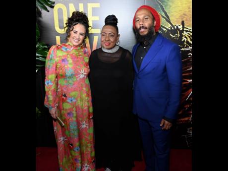 Minister of Culture, Gender, Entertainment and Sports, Olivia ‘Babsy’ Grange is flanked by reggae royalty, Ziggy Marley (right) and his wife, Orly, at last Tuesday’s premiere of the biopic, ‘Bob Marley: One Love’.    
