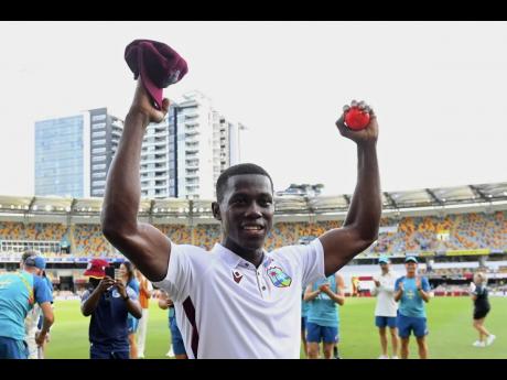 West Indies fast bowler Shamar Joseph raises the ball after taking seven wickets in his team’s eight-run win over Australia on the fourth day of the second Test in Brisbane, Sunday, January 28, 2024. 