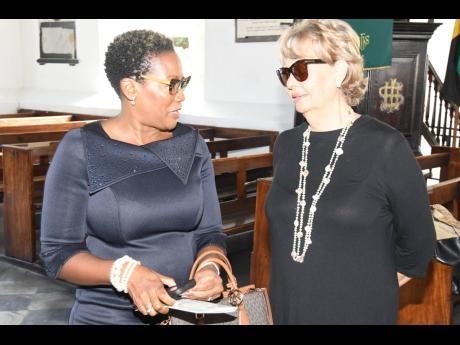 Executive director of the Private Sector Organisation of Jamaica Sacha Vaccianna-Riley (left) exchanges greetings with consultant Patricia Francis during the Shipping Association of Jamaica’s anniversary service of thanksgiving.