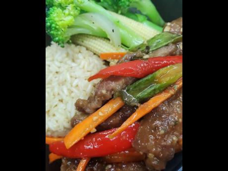 This tasty Mongolian beef is accompanied by steamed vegetables and white rice.