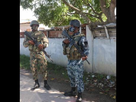 Members of the Jamaica Defense Force (JDF) on the Ricketts street in Savanna-La-Mar, Westmoreland. This community has a SOE checkpoint.