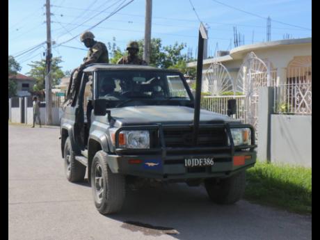 Members of the Jamaica Defense Force (JDF) on the Ricketts street in Savanna-La-Mar, Westmoreland. This community has a SOE checkpoint.
