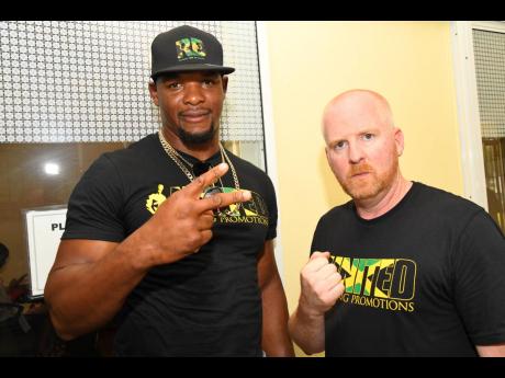 Ricardo ‘Big 12’ Brown (left) and his promoter, Tyler Buxton of United Boxing Promotions, at SureTime Medical Centre on Trafalgar Road in New Kingston on Friday, October 6, 2023.