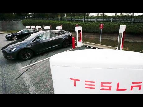 Tesla vehicles charge at a station, in Woodstock, Georgia.