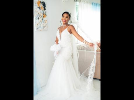 Without a specific design in mind, Jahneil desired a wedding dress that would accentuate her curves. She found just that in this white fit-and-flare luxury gown, adorned with silver accents that added a touch of shimmer.