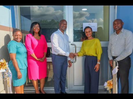 Kingston Wharves Limited (KWL) CEO Mark Williams (third left) and Medical Associates Vice-President for Strategic Growth and Operations Toni Cooke (second right) seal the deal following the ribbon-cutting ceremony to officially open KWL’s Medical Centre 
