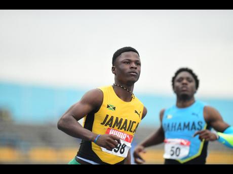 DeAndre Daley competing in the 100 metres at the 2022 Carifta Games at the National Stadium. 
