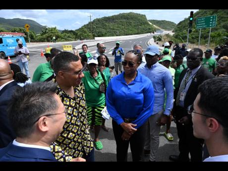 Prime Minister Andrew Holness (second left) chats with Chen Daojiang (left), ambassador of the People’s Republic of China; Juliet Holness, member of parliament, St Andrew East Rural, and other officials during the event to mark the official opening of Pa