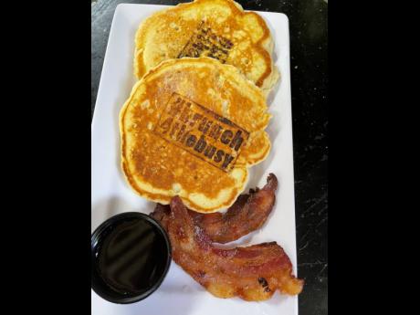 Pancakes anyone? Bearing the signature stamp, the staple is accompanied by a side of ham and maple syrup.
