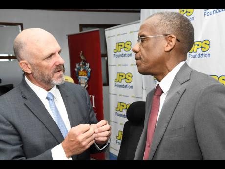 
Former JPS President and CEO Steve Berberich (left) speaking with Dr Tomlin Paul, UWI deputy principal, Mona, at the MOU Signing between JPS Foundation and The UWI CAPE Workshops at JPS head office on Knutsford Boulevard in New Kingston on Thursday, Augus