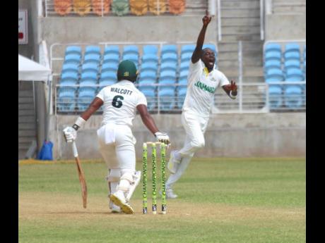 Jamaica Scorpions pacer Gordon Bryan (right)  celebrates after  dismissing Windward Islands Volcanoes batter Tevin Walcott on day two of their West Indies Championship encounter at Sabina Park yesterday.