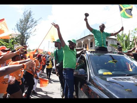 Dwight Sibblies, member of parliament for Clarendon Northern, lead a motorcade through a sea of People’s National Party supporters on his way through Kellits to nominate the Jamaica Labour Party’s three councillor-candidates in his constituency at the 