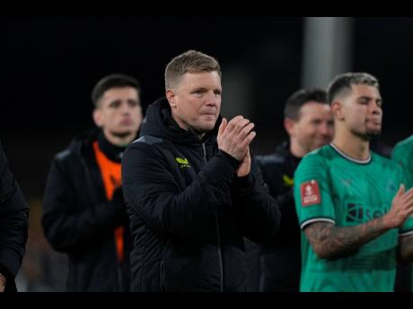Newcastle’s head coach Eddie Howe applauds fans at the end of the English FA Cup fourth-round match between Fulham and Newcastle United at Craven Cottage stadium in London, Saturday, January 27, 2024. 