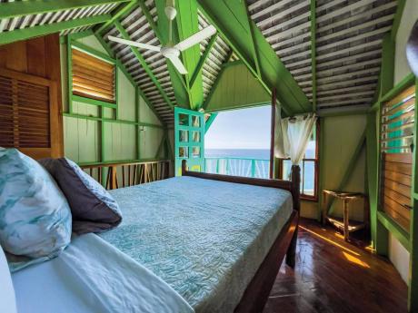  The upstairs bedroom thrills you with its balcony floating above the edge of the steep cliff.