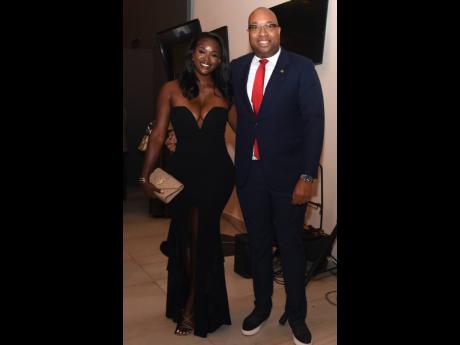 Daneil Campbell (left), wows in a strapless, curve-hugging gown as she shares lens with Delano Seiveright, chief strategist and adviser in the Ministry of Tourism.