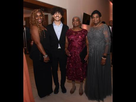 Keisha Wilson (left) shares lens with Dante Neri and Cynthia Bartlett and Edna Nelson, the sisters of Edmund Bartlett. 