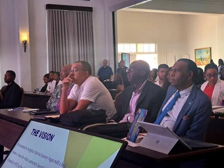 (In the foreground from left): Health Minister Dr Christopher Tufton; Patrick Hylton, chairman of the University Hospital of the West Indies’ board of management; and Wilford ‘Billy’ Heaven, chief executive officer of the CHASE Fund, sit together dur