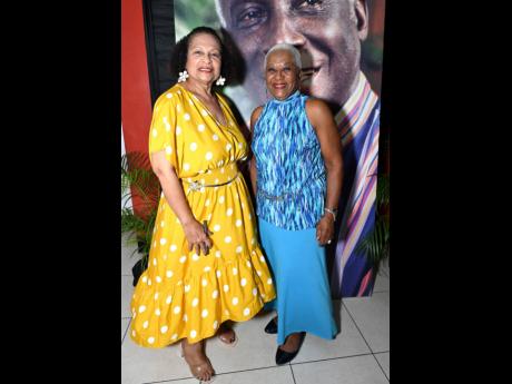 Maxine Brown (left) and Paulette Mitchell, director of the National Chorale of Jamaica, don bright colours  for the event. 