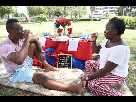 Howard Marks and his wife, Natalee Marks, celebrating Valentine’s Day with a picnic inside Emancipation Park in New Kingston yesterday. 