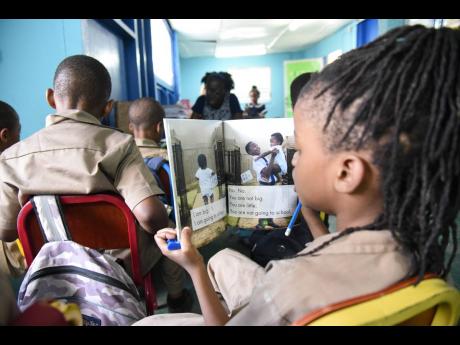 Students of Grove Primary School, St Andrew, reading during the ‘drop everything and read’ session held recently. 