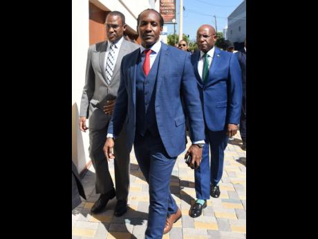 Blue and grey suits were the order of the day for (from left) Finance Minister Nigel Clarke, State Minister in the Ministry of Foreign Affairs and Foreign Trade Alando Terrelonge, and  Minister of Industry, Investment and Commerce Senator Aubyn Hill.  