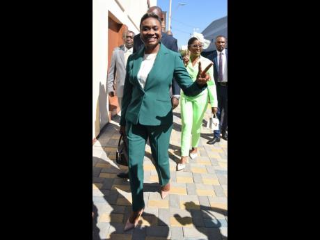 Their shades of green may be differing, but members of parliament Juliet Cuthbert-Flynn (left) and Michelle Charles are twinning with the poses. 