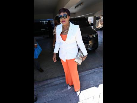 Complementing her signature orange and white, Member of Parliament Denise Daley adds a touch of neutrality with these nude pumps and matching clutch.  