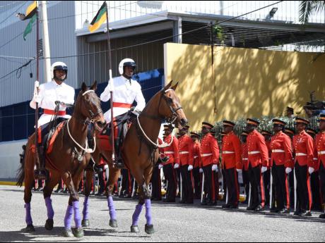 Member of the security forces take part in the ceremonial opening of Parliament on Duke Street in Kingston on Thursday.