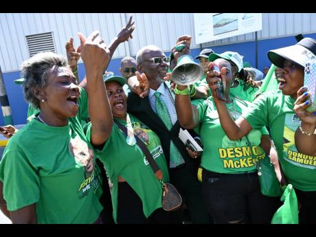 Jamaica Labour Party (JLP) supporters embrace Kingston Western Member of Parliament and Local Government Minister Desmond McKenzie.