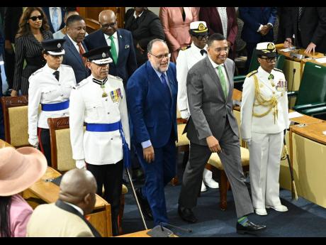 Prime Minister Andrew Holness (second right) and Opposition Leader Mark Golding (second left) lead the Government and Opposition parliamentarians, respectively, into Gordon House on Thursday past Police Commissioner Major General Antony Anderson (left) and