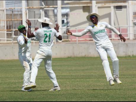 Jamaica Scorpions captain Jermaine Blackwood (left) celebrates with Ojay Shields (centre) and Carlos Brown after the team picked up the wicket of Jonathan Carter of Combined Campuses and Colleges during their West Indies Championship encounter at Sabina Pa