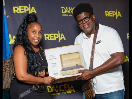  Latonya Style, dance instructor and founder of Dance JA Academy and the Dance JA Awards, presents promoter of Uptown Mondays, Whitfield ‘Witty’ Henry, with a gift for his contribution to dancehall and his support of dancers in the community. 
