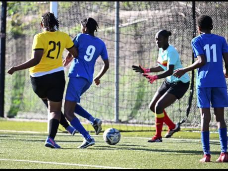 Cavalier’s Sashanna Watson (left) scores past goalkeeper Jonique McFarlane while under pressure from Proven Girls FC’s Keylee Edwards during last Saturday’s Jamaica Women’s Professional League match at the UWI-JFF Captain Horace Burrell Centre of E