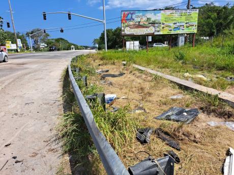  Broken car parts in the vicinity of the crash site along the intersection of the Daniel Town main road and the North Coast Highway in Trelawny, where a Toyota Mark X motorcar collided with an Audi Q3 motorcar early Sunday morning. Four men who were in the
