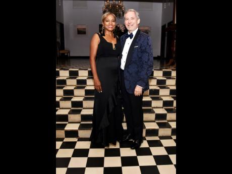 Suzanne Bowen exuded grace in a black gown complemented by matching tassel earrings as she poses alongside her husband, Bruce Bowen, chief executive officer of National Commercial Bank.